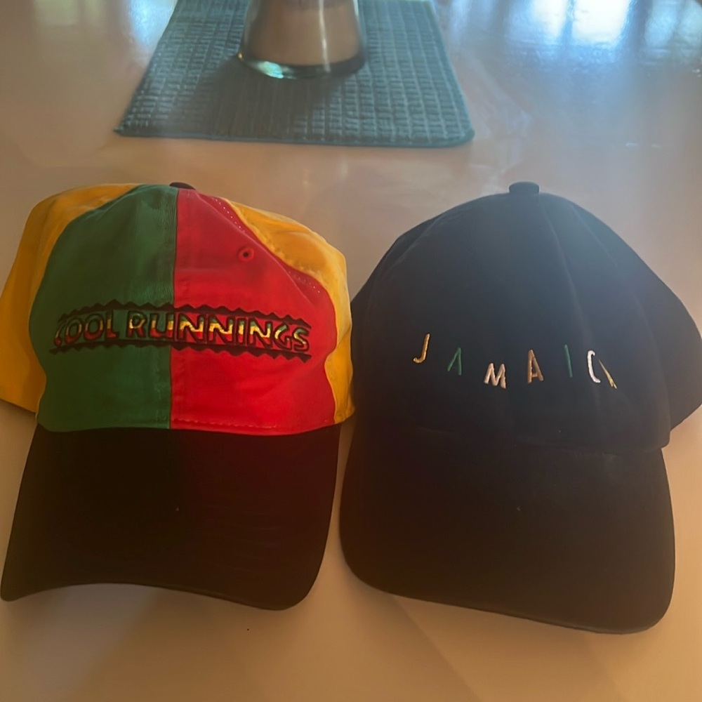 Two hats, one says Cool Runnings the other Jamaica.